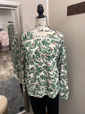 A white top with green watercolor leaves and red watercolor holly berries in groups of three.